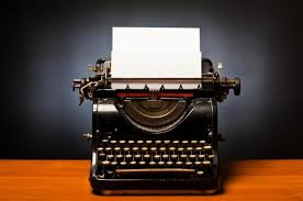 A typewriter with a blank page ready to be filled with a riveting story for the National Novel Writing Month challenge.